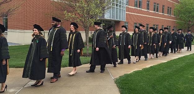 Pharmacy and Master of Athletic Training candidates move toward Cordier for  Commencement 2016.